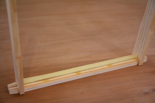 The completed frame with starter strip, ready to go back into the hive box.