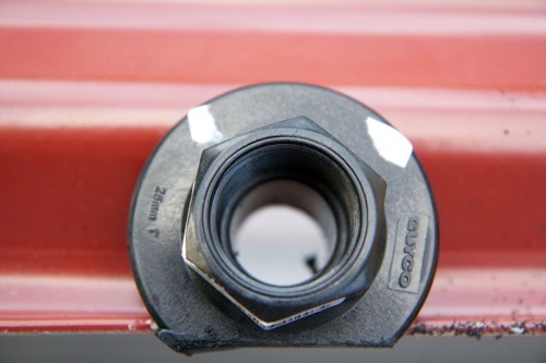 The threaded tank outlet in place, trimmed a little to fit.