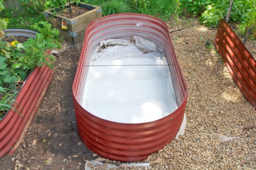 Geotextile fabric in place -- now to fill the bed back up!