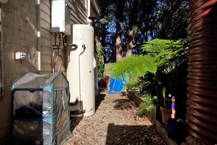 The 300L tank gets squeezed into the side passage of the house.